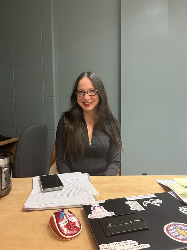 Ashley Perna sitting at her desk. 